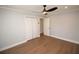 Bright bedroom featuring hardwood floors, a modern ceiling fan and a closet with bi-fold doors at 127 Marona Ne St, Atlanta, GA 30307