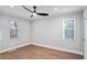 This vacant bedroom has two windows with hardwood floors and neutral paint at 127 Marona Ne St, Atlanta, GA 30307