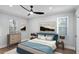 Staged bedroom includes a ceiling fan, two windows and neutral colors at 127 Marona Ne St, Atlanta, GA 30307