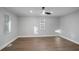 A clean and bright room featuring hardwood floors, white walls, a ceiling fan and large windows at 127 Marona Ne St, Atlanta, GA 30307