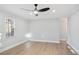 Light-filled room featuring hardwood floors, a modern ceiling fan, white walls, and windows for an open and airy feel at 127 Marona Ne St, Atlanta, GA 30307
