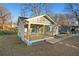 Quaint home exterior with light blue siding, a cozy front porch, and a well-kept lawn, creating a welcoming curb appeal at 127 Marona Ne St, Atlanta, GA 30307