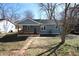 Charming light blue home featuring a cozy front porch and manicured lawn at 127 Marona Ne St, Atlanta, GA 30307