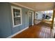 The home's inviting front porch features a wooden floor and a light blue exterior with white trim and a green front door at 127 Marona Ne St, Atlanta, GA 30307