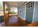 Inviting front porch featuring wooden floors and railing, with a charming light blue exterior and a green front door at 127 Marona Ne St, Atlanta, GA 30307