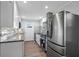 Updated kitchen features stainless steel appliances, gray countertops and stylish gray backsplash at 127 Marona Ne St, Atlanta, GA 30307