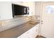 This kitchen features updated gray countertops, stainless steel appliances and herringbone backsplash at 127 Marona Ne St, Atlanta, GA 30307