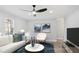 Cozy living room showcasing a white sectional sofa, modern decor, hardwood flooring, and plenty of natural light at 127 Marona Ne St, Atlanta, GA 30307