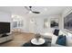 The living room has hardwood floors, a ceiling fan, an L-shaped sofa, a round coffee table and an eat-in kitchen at 127 Marona Ne St, Atlanta, GA 30307