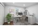 This home office is staged with a white desk and a plant in front of the window at 127 Marona Ne St, Atlanta, GA 30307