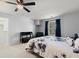 Bedroom featuring a black ceiling fan and a bed with a modern blue and white flower patterned bed spread at 1945 Millers Path, Cumming, GA 30041