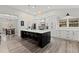 Bright kitchen with white cabinetry, a large center island, and modern appliances at 1945 Millers Path, Cumming, GA 30041