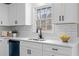 Well-lit kitchen featuring white cabinetry, stainless steel sink, and quartz countertops at 25 Queen Ct, Carrollton, GA 30116