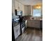 Well-equipped kitchen features white cabinets, granite countertops, and stainless steel appliances at 641 Spring Forest Dr, Lawrenceville, GA 30043