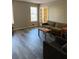 Bright living room features neutral walls, gray wood floors, and french doors at 641 Spring Forest Dr, Lawrenceville, GA 30043
