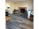 Cozy living room features a brick fireplace, neutral walls, and gray wood floors at 641 Spring Forest Dr, Lawrenceville, GA 30043