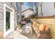 Inviting back patio featuring comfortable seating, a dining area, and a well-maintained yard at 105 Kinross Ct, Roswell, GA 30076