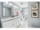 Stylish bathroom with a double vanity, granite countertops, framed mirrors, and elegant lighting fixtures at 105 Kinross Ct, Roswell, GA 30076