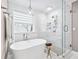 Elegant bathroom with soaking tub and glass-enclosed shower at 105 Kinross Ct, Roswell, GA 30076