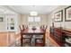 Elegant dining room with a large table, chandelier, and natural light from the window at 105 Kinross Ct, Roswell, GA 30076