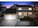 Charming gray two-story home at dusk, showcasing a welcoming facade and attached garage at 105 Kinross Ct, Roswell, GA 30076