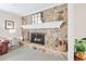 A stone fireplace with a white mantel, a decorative mirror, and a hearth with a metal fire screen at 105 Kinross Ct, Roswell, GA 30076