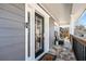 Inviting covered front porch with stone flooring and comfortable seating area at 105 Kinross Ct, Roswell, GA 30076