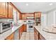 Well-appointed kitchen featuring stainless steel appliances, granite countertops, and ample cabinet space at 105 Kinross Ct, Roswell, GA 30076