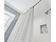 Modern shower featuring subway tile, a decorative niche, and a stylish shower curtain for a clean and refreshing experience at 105 Kinross Ct, Roswell, GA 30076