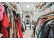Bright walk-in closet featuring ample shelving and hanging space for optimal organization and clothing care at 105 Kinross Ct, Roswell, GA 30076