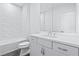 Modern bathroom with subway tile shower, white cabinets, and sleek fixtures at 484 Hammons Way, Atlanta, GA 30315