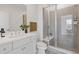 Bright bathroom featuring a glass enclosed shower with built in seat, tiled floors and a white vanity at 484 Hammons Way, Atlanta, GA 30315
