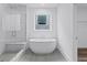 Relaxing bathroom with a freestanding tub, a glass-enclosed shower, and a window at 484 Hammons Way, Atlanta, GA 30315