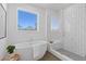 Elegant bathroom with a soaking tub, tiled shower, and a bright window at 484 Hammons Way, Atlanta, GA 30315