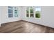 Light-filled bedroom with hardwood floors and three windows offering scenic views at 484 Hammons Way, Atlanta, GA 30315