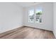 Sunlit bedroom featuring gleaming hardwood floors and double windows at 484 Hammons Way, Atlanta, GA 30315