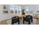 Bright dining room with large windows, modern decor, hardwood floors, and stylish seating at 484 Hammons Way, Atlanta, GA 30315