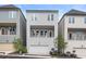 Three-story townhome featuring multi-car garage and covered porch at 484 Hammons Way, Atlanta, GA 30315