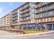 Exterior shot of a modern apartment building with balconies and ground-level retail spaces at 484 Hammons Way, Atlanta, GA 30315