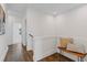 Upstairs hallway with wood floors, a bench with decorative pillows, and bright lighting at 484 Hammons Way, Atlanta, GA 30315