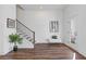 Entry hallway with dark hardwood flooring, a staircase with iron railing, and a white bench at 484 Hammons Way, Atlanta, GA 30315