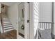 Hallway with wood flooring, an iron railing staircase, and access to an outdoor porch at 484 Hammons Way, Atlanta, GA 30315