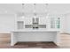 Modern kitchen with a large island, pendant lighting, stainless steel appliances, and tile backsplash at 484 Hammons Way, Atlanta, GA 30315