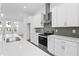 Stylish kitchen showcasing white cabinetry, stainless steel appliances, and a kitchen island at 484 Hammons Way, Atlanta, GA 30315