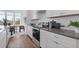 Well-lit kitchen featuring modern appliances, light cabinets, stainless steel accents, and hardwood floors at 484 Hammons Way, Atlanta, GA 30315