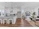 Open concept living room with white kitchen, hardwood floors, recessed lights and modern fireplace at 484 Hammons Way, Atlanta, GA 30315