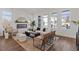 Bright and airy living room with a fireplace, hardwood floors, and three large windows at 484 Hammons Way, Atlanta, GA 30315