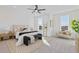 Spacious main bedroom with light grey carpet, a large window and seating area at 484 Hammons Way, Atlanta, GA 30315