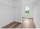 Bright walk-in closet with wood floor, wire racks and a sun-filled window at 484 Hammons Way, Atlanta, GA 30315