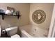 Well-maintained bathroom featuring a tub, modern toilet, and decorative wall art at 637 Outlook Way, Atlanta, GA 30349